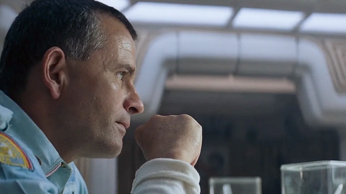 Ian Holm looks across the table in Alien.