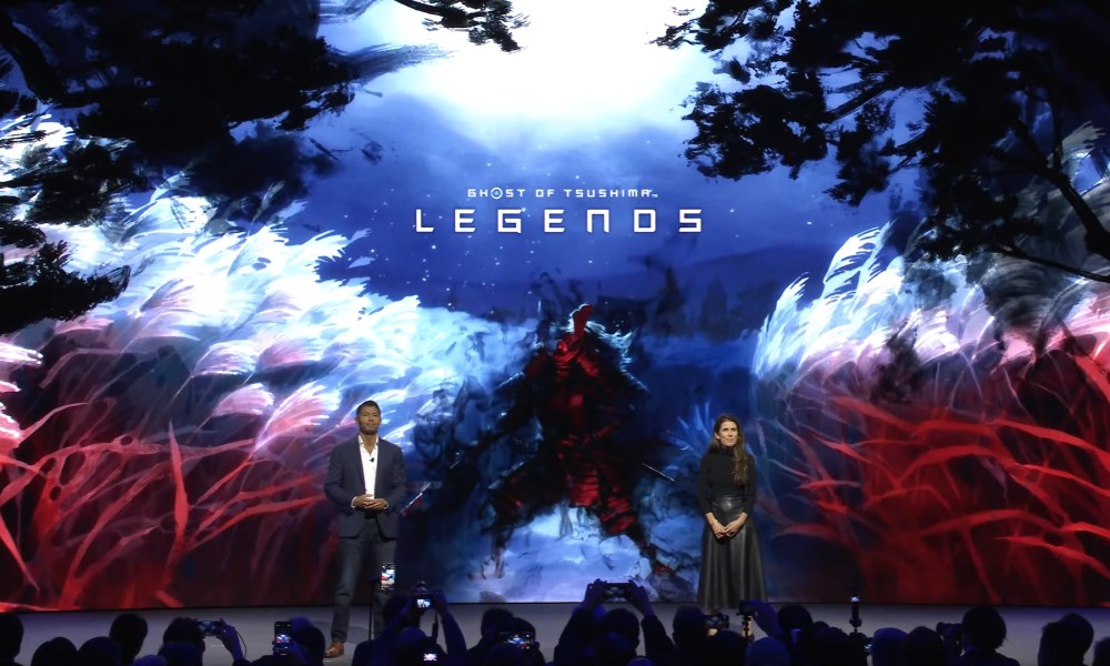 Sony Pictures executives stand in front of key art for Ghost of Tsushima: Legends.