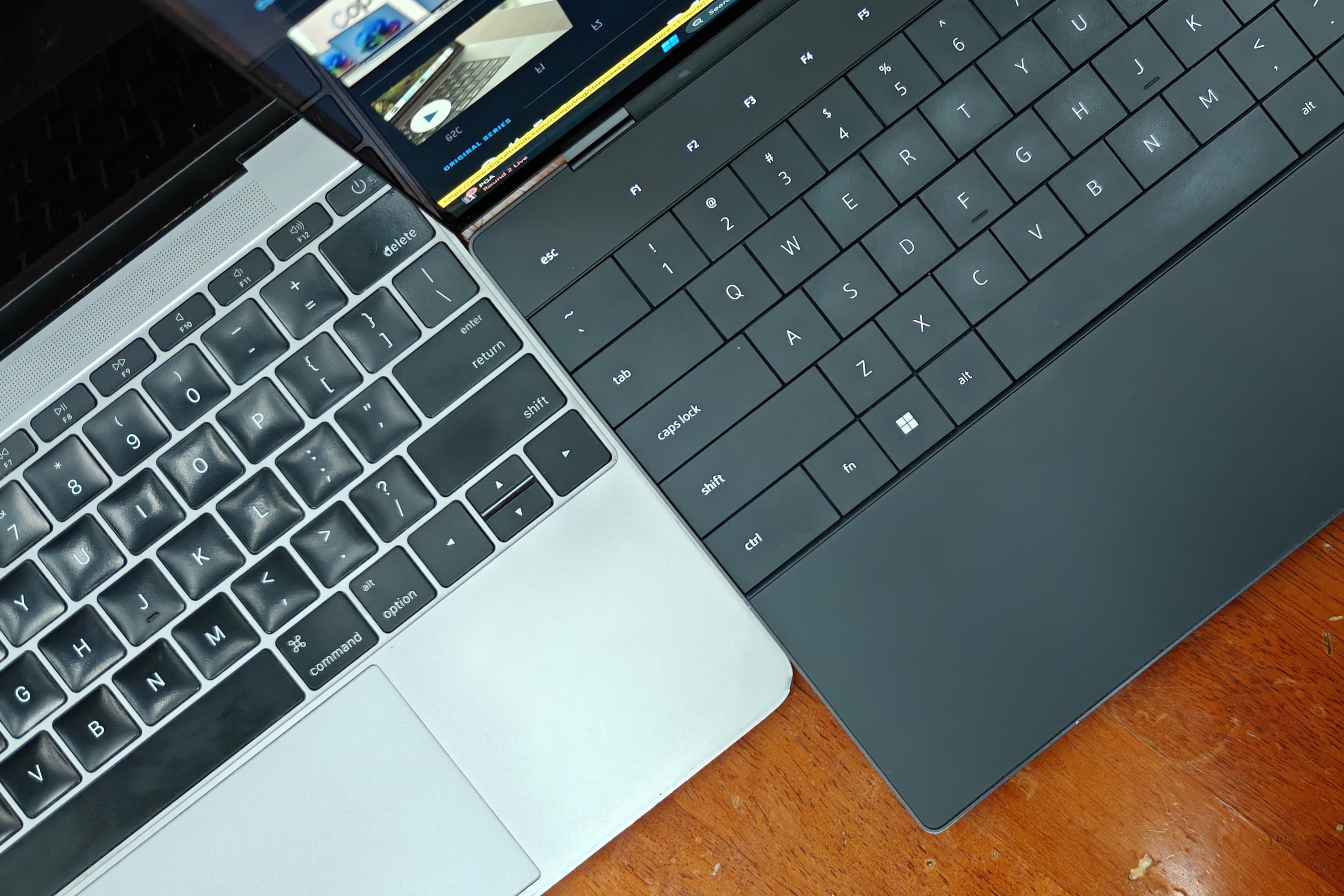 Dell XPS 13 and 12-inch MacBook side by side.