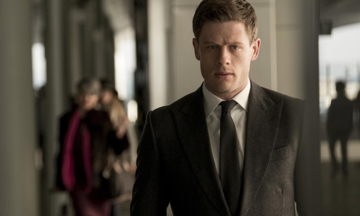 A man in a suit stares down in McMafia.