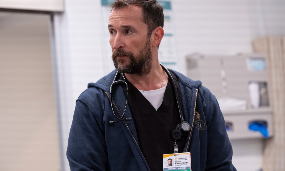 Noah Wyle wears a hoodie and hospital scrubs in The Pitt.