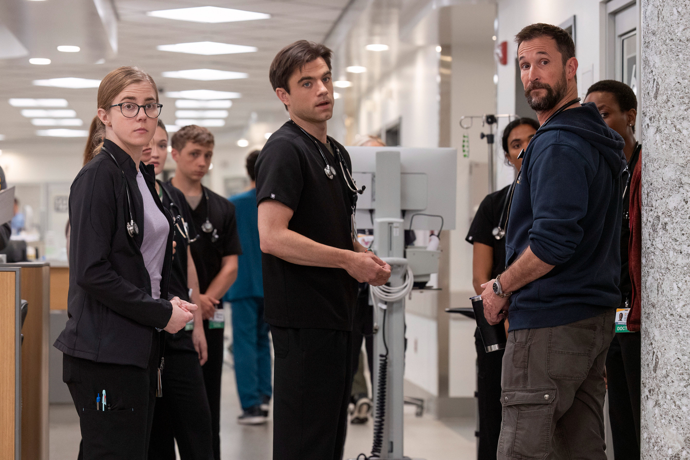 Patrick Ball stands next to Noah Wyle in The Pitt.