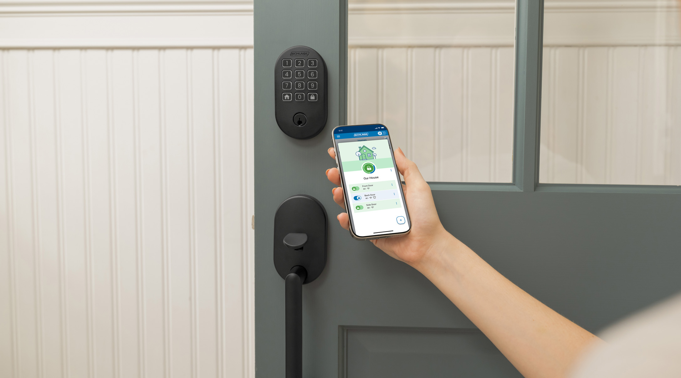 Someone using the Schlage Home app to unlock the Schlage Arrive lock.