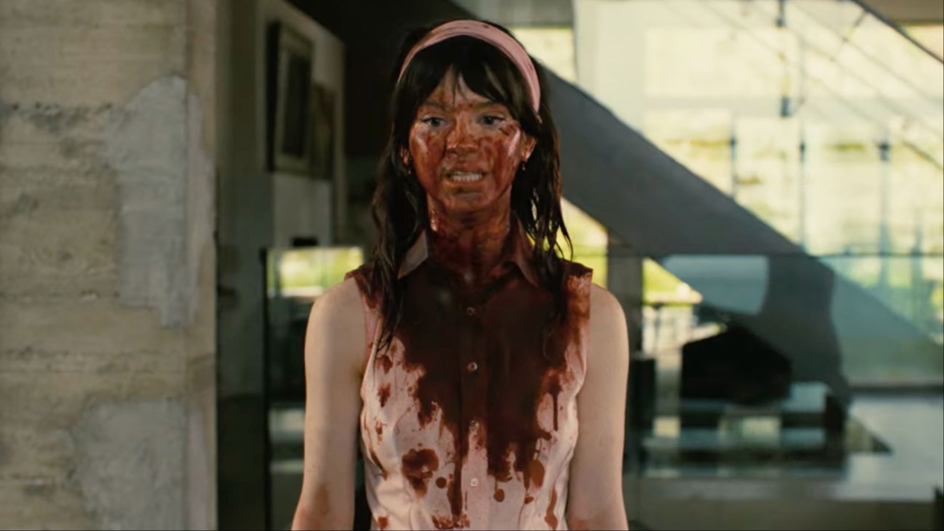 A woman covered in blood stands and stares in Companion.