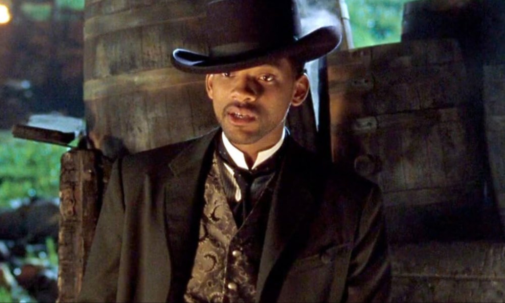 Will Smith stands against a barrel in Wild Wild West.