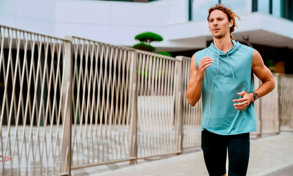 A person running while wearing the Amazfit Active Smartwatch.