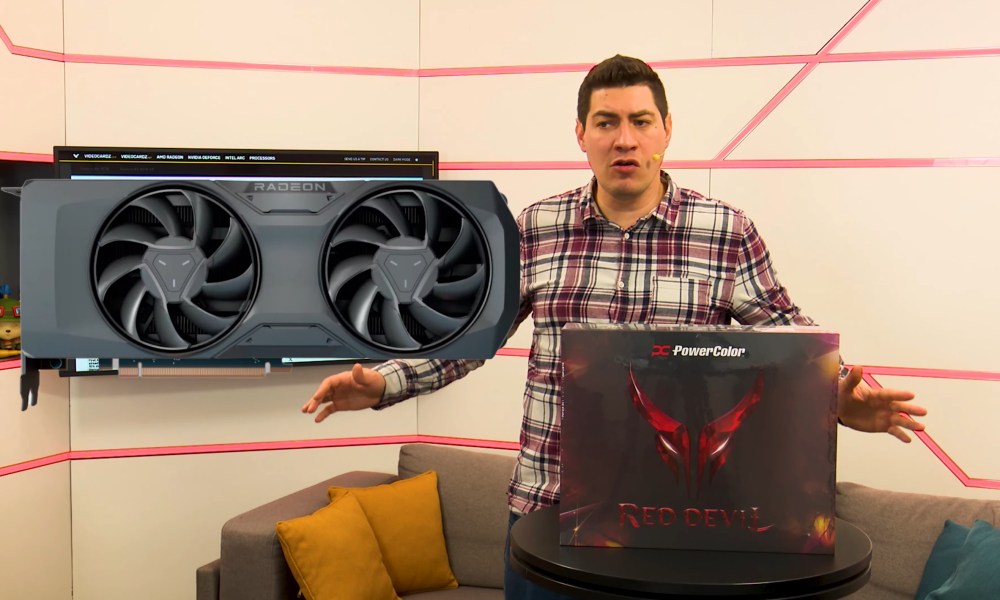 A man showcases the RX 9070 XT PowerColor Red Devil box.