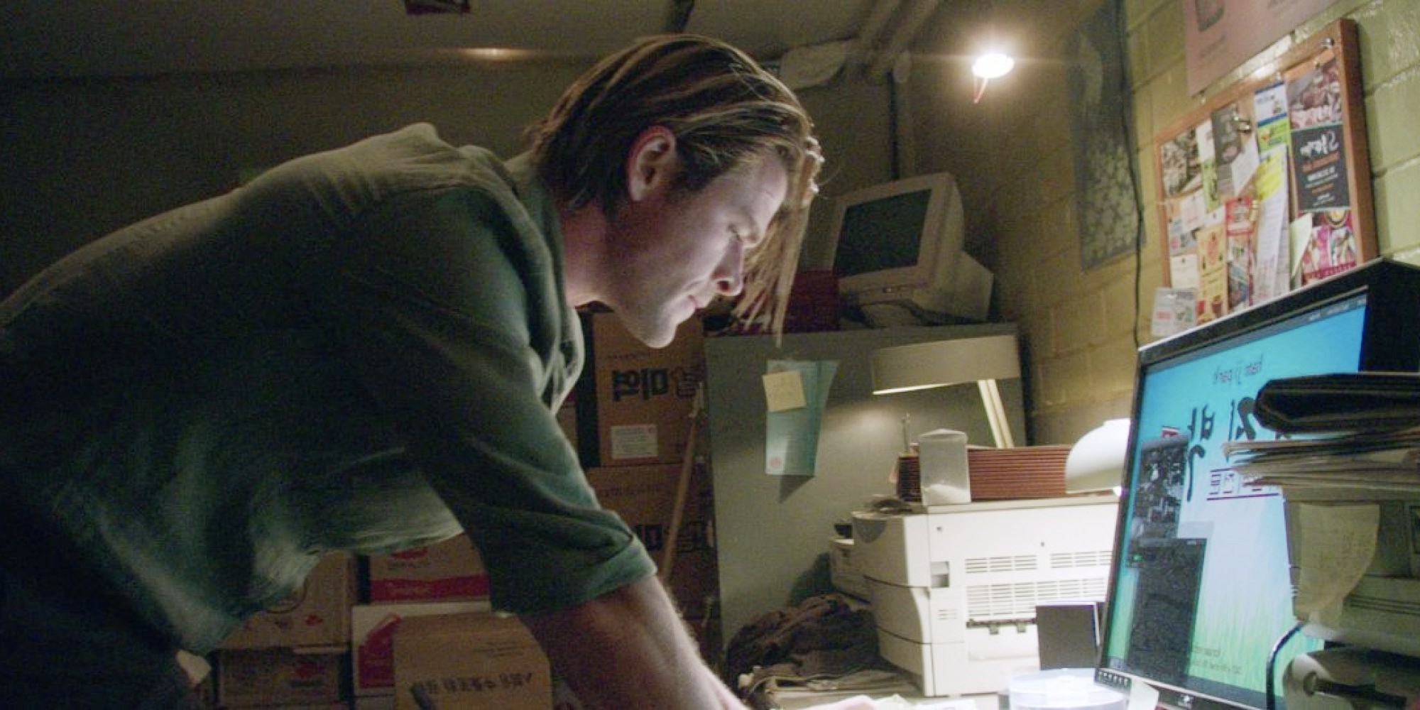 A man leans in front of his computer in Blackhat.