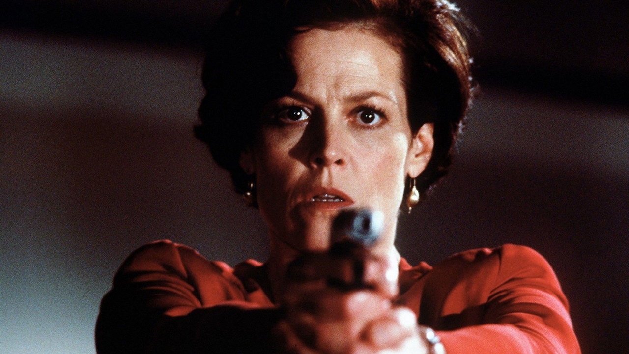 Sigourney Weaver looking scared holding out a gun in Copycat.