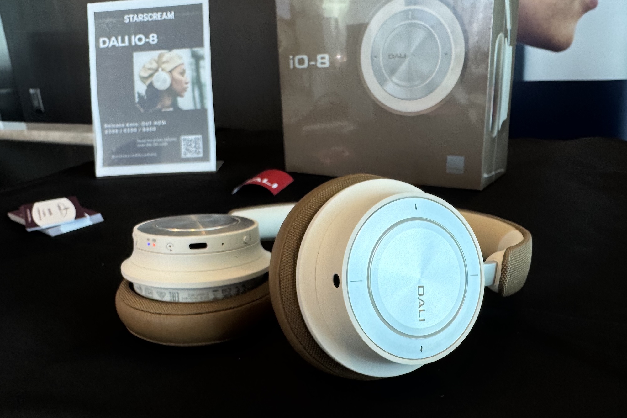 Dali IO-8 headphones on a black velvet table at a CES 2025 demo.