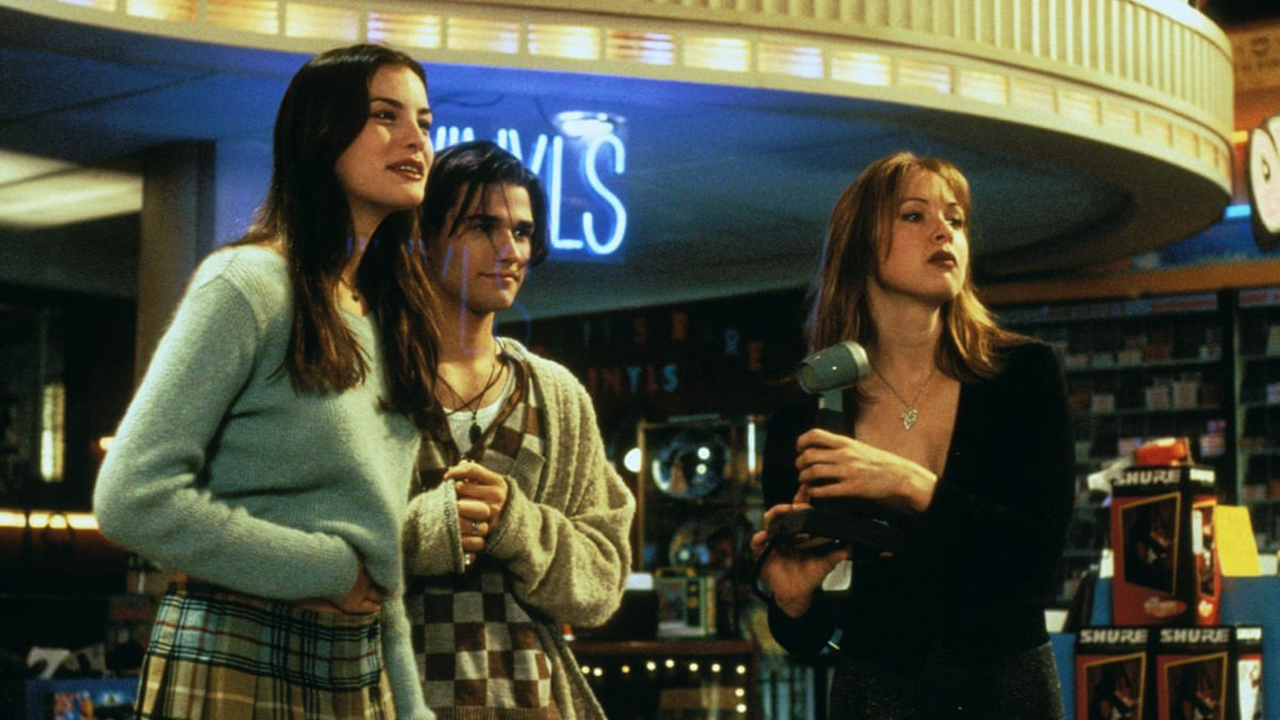 Three young people standing in a record store in Empire Records. 