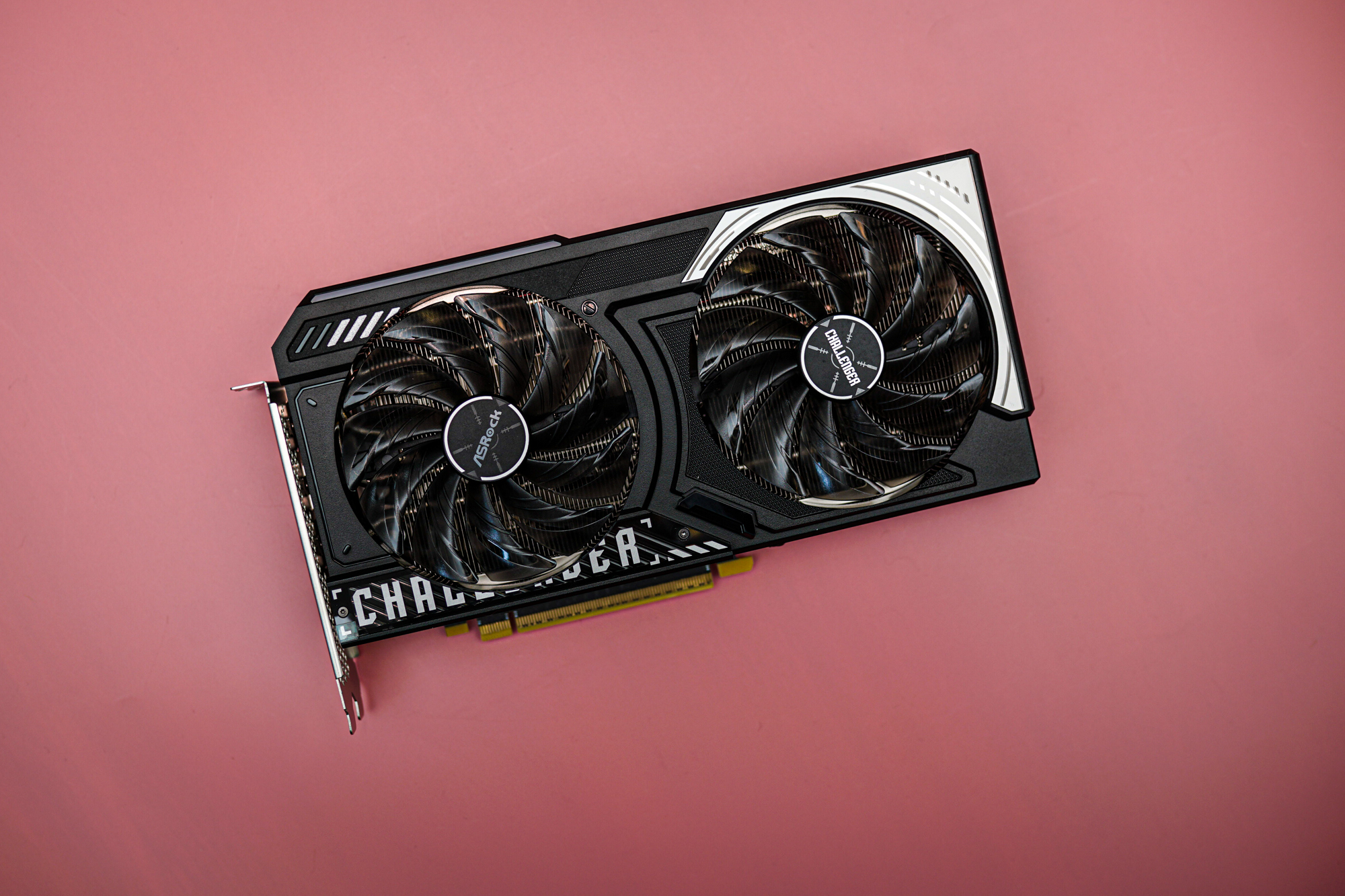 The Intel Arc B570 sitting on a pink background.