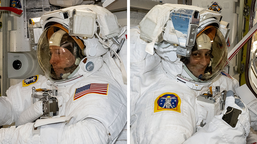 NASA astronauts Nick Hague and Suni Williams, both NASA astronauts, are pictured evaluating their spacesuits in a pressurized configuration in the Quest airlock.