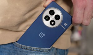 A person taking the OnePlus 13 out of a pocket.