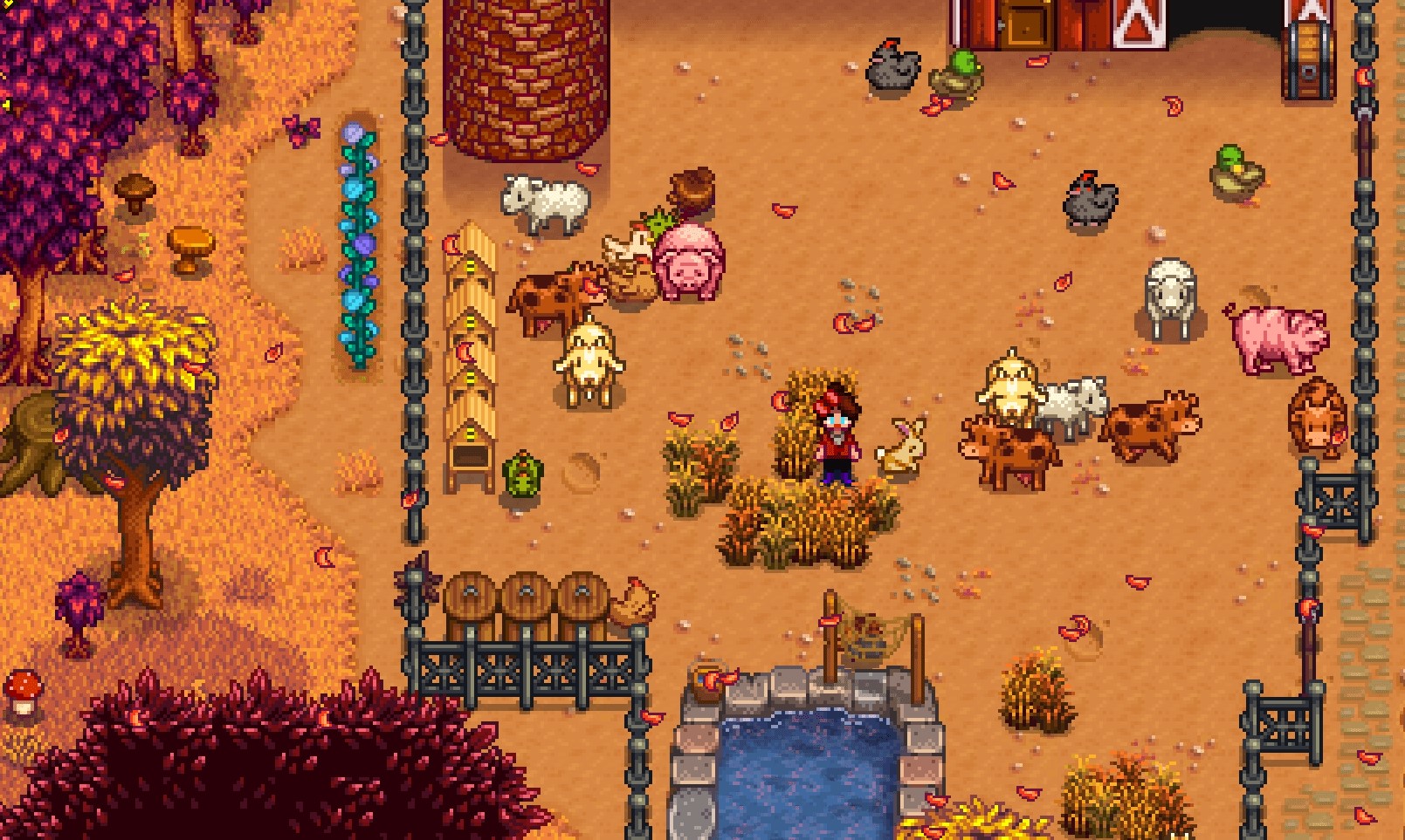 The farmer standing in a pen with lots of farm animals.