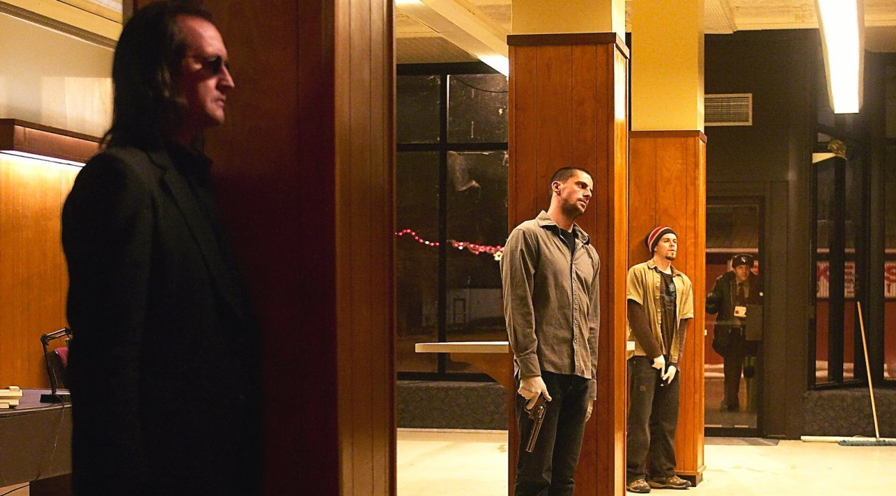 Three men with guns stand in a bank in The Lookout.