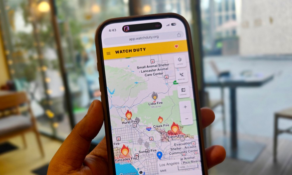 Person using the Watch Duty fire tracker app on their iPhone.