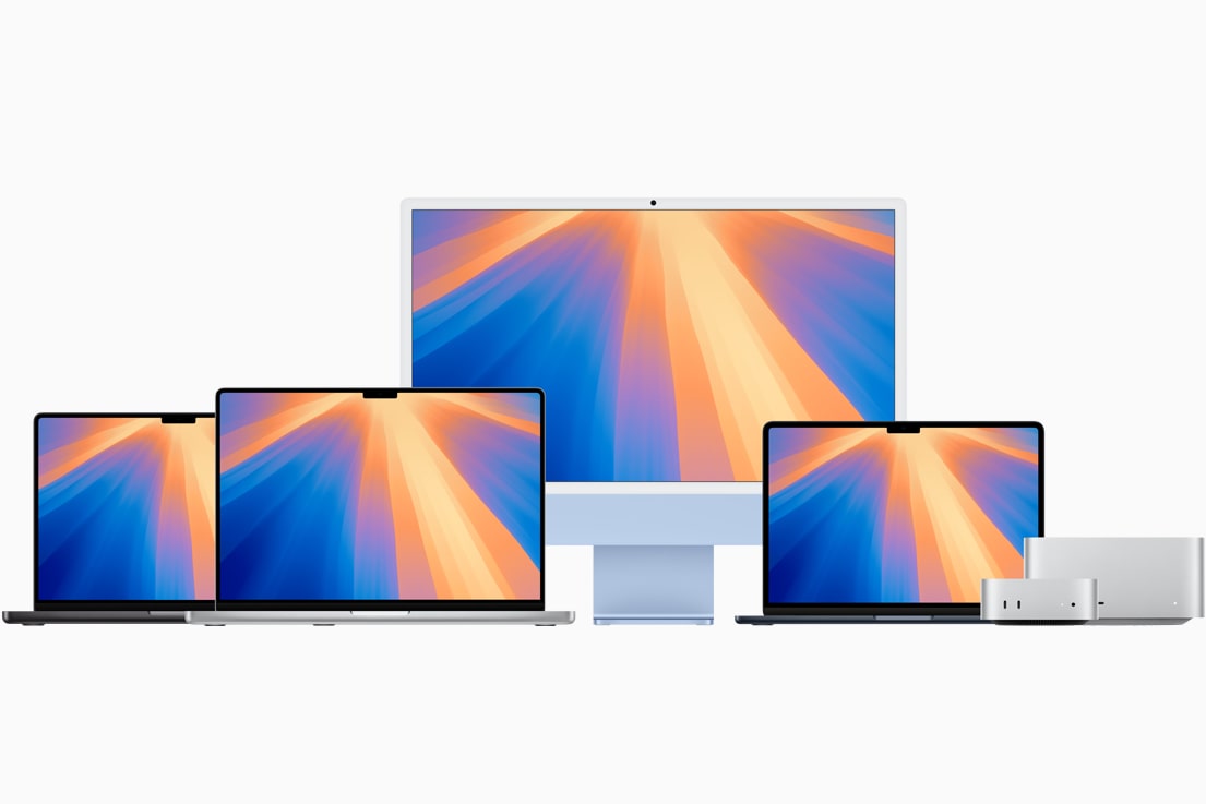 A range of Apple Macs against a gray background.