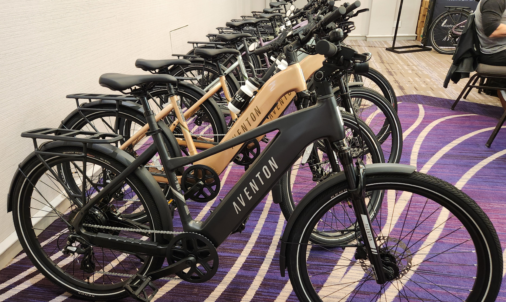 Aventon Level 3 e-bikes lined up at a pre-launch press event.