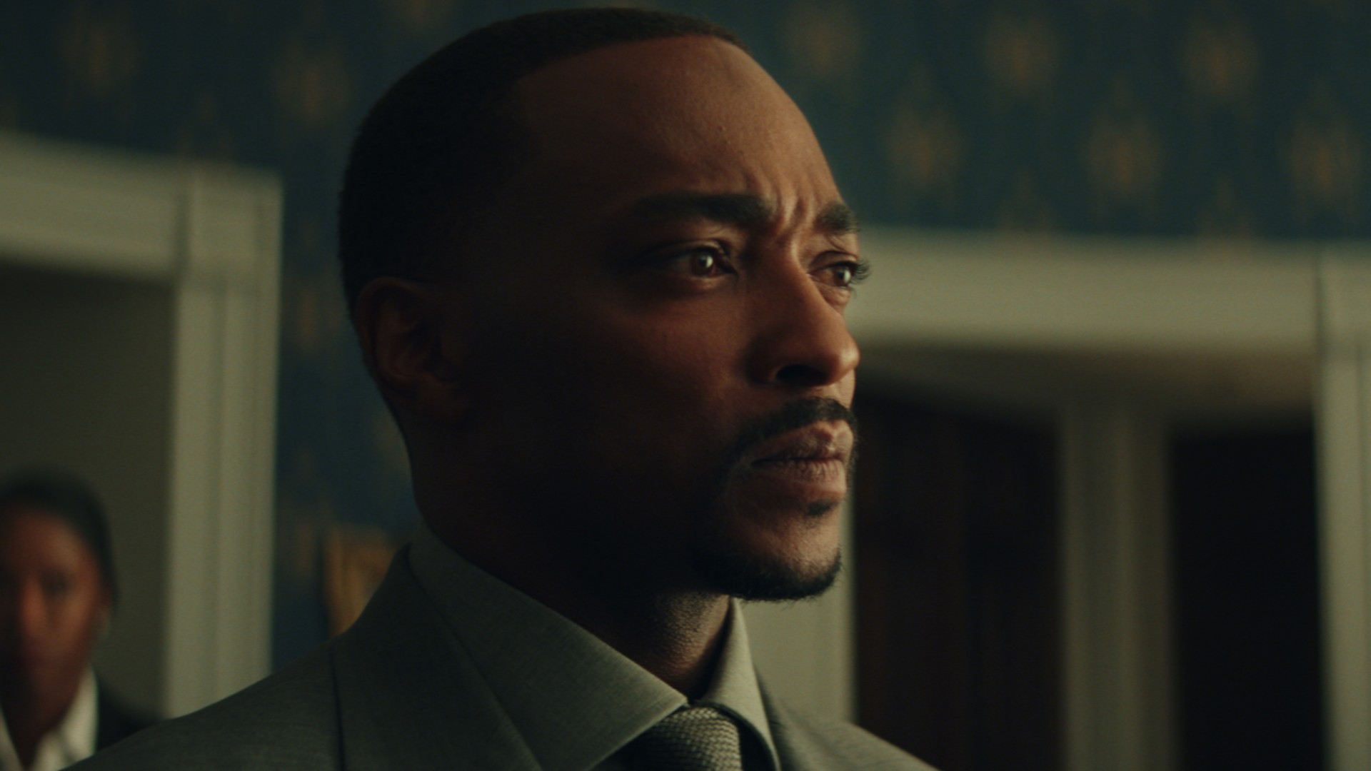 Anthony Mackie parece preocupado em um close do filme Capitão América: Admirável Mundo Novo.