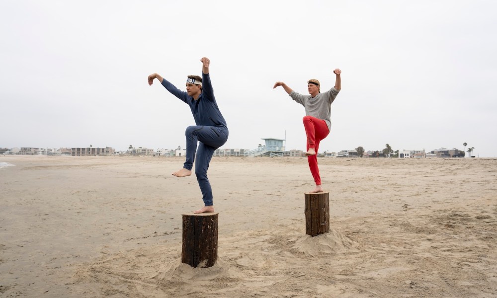 Daniel and Johnny stand on stumps and kick in Cobra Kai season 6.