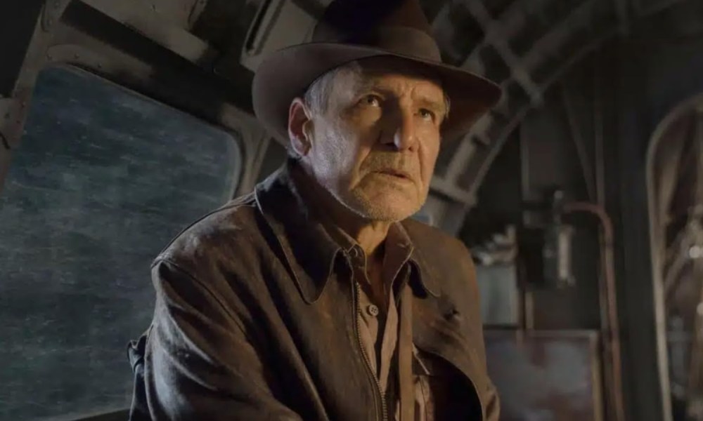 Harrison Ford sits and looks up in Indiana Jones and the Dial of Destiny.