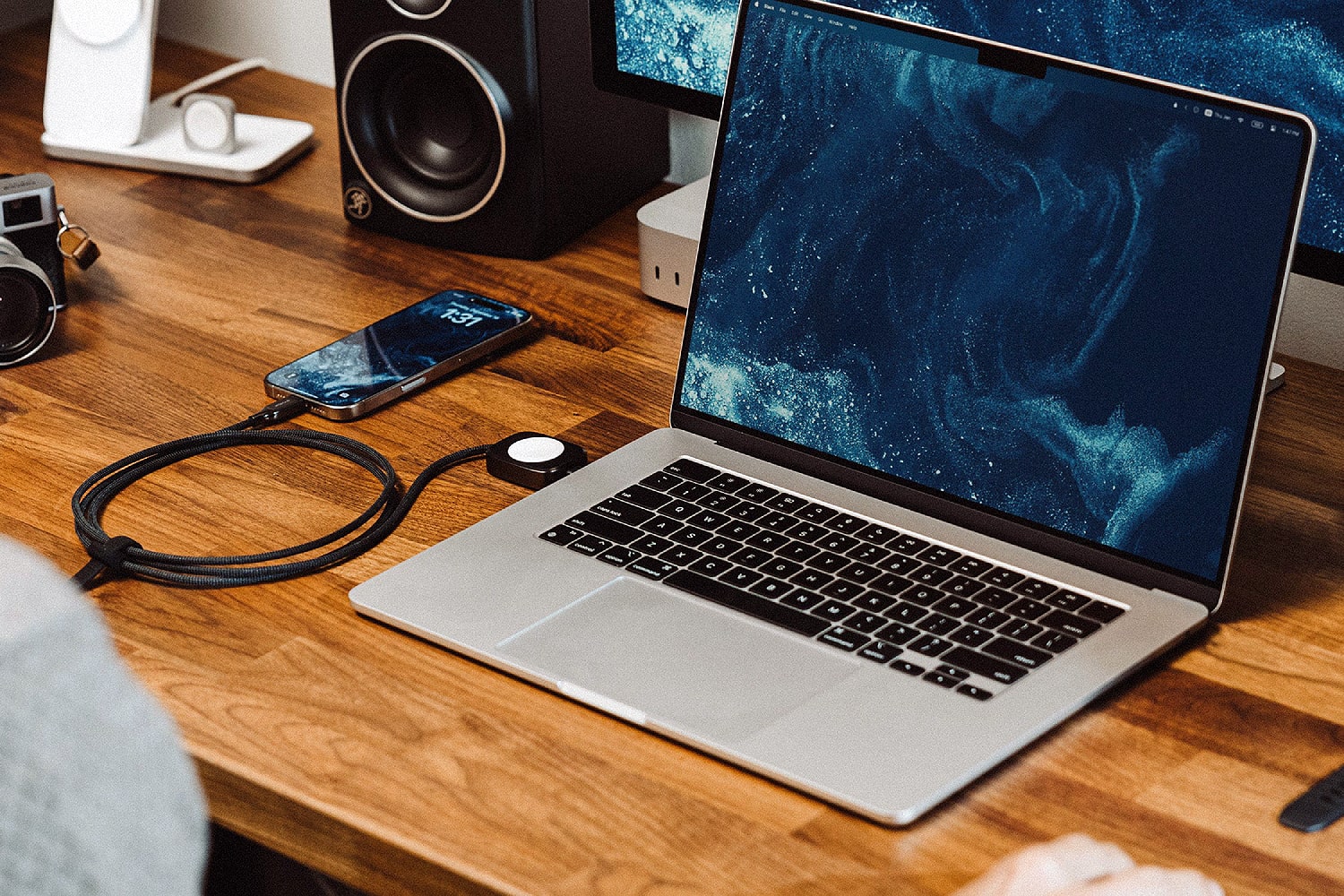 The Nomad Universal Cable for Apple Watch being used to charge Apple devices.