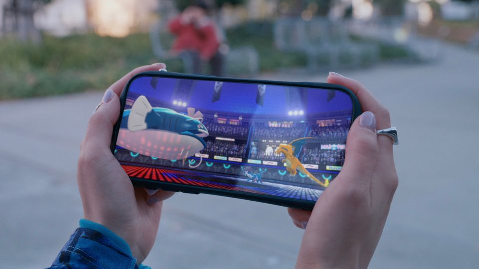 Pokémon Champions being played on a mobile phone.