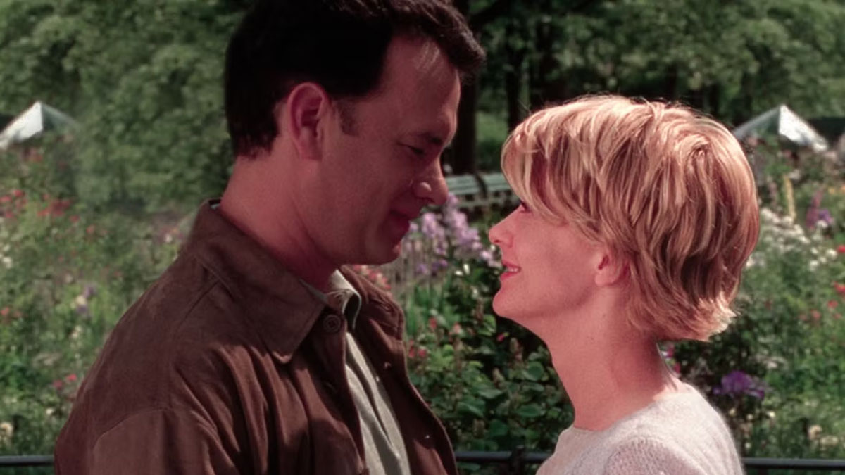 Tom Hanks and Meg Ryan lean in during a scene from You've Got Mail.