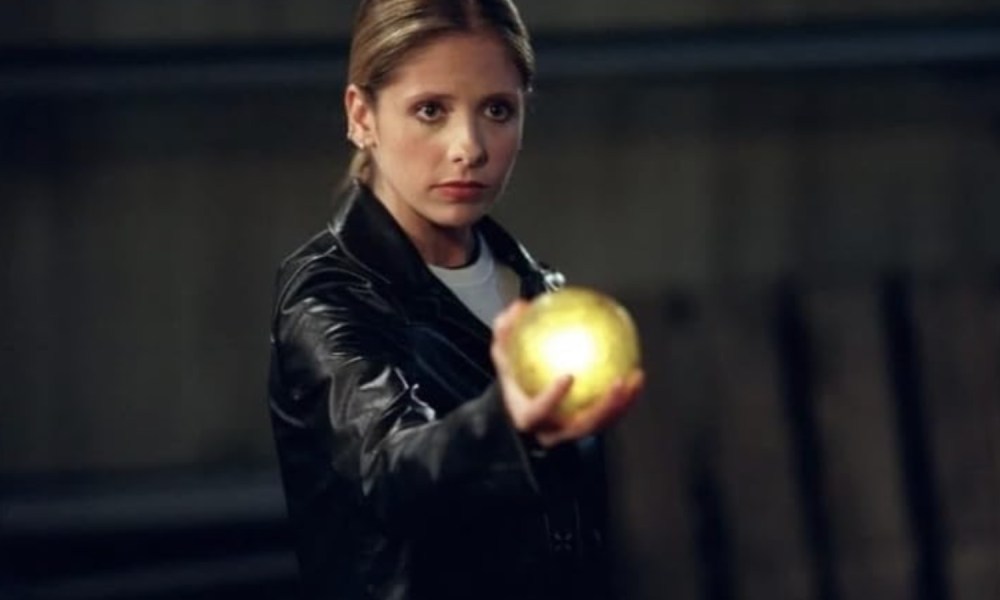 Buffy holds out a gold orb in Buffy the Vampire Slayer.