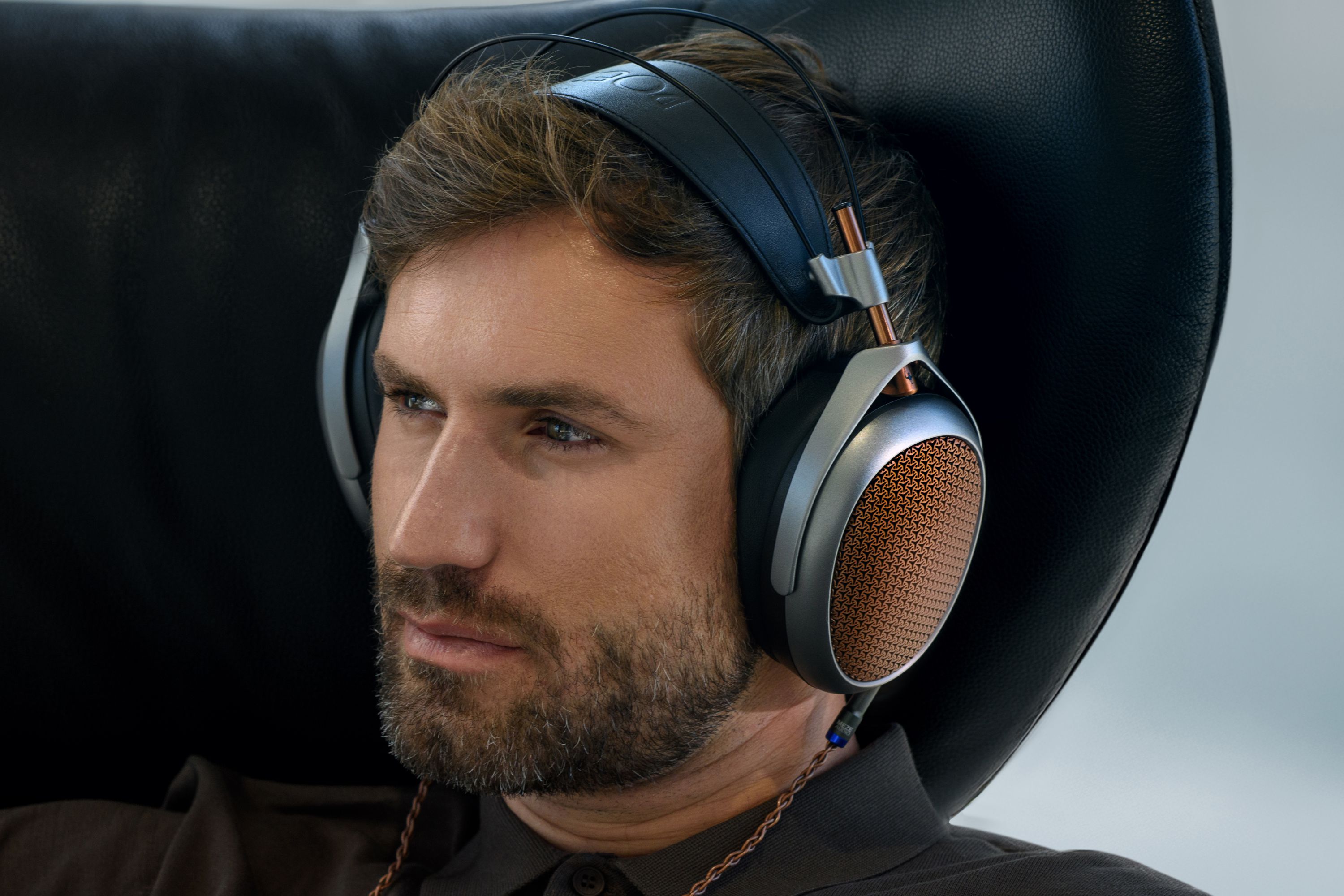 Man wearing Meze Audio Poet headphones.