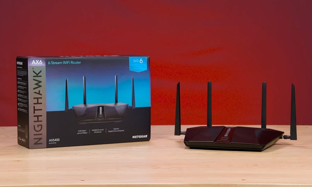 The Netgear Nighthawk XR1000v2 router placed on a desk next to its packaging box