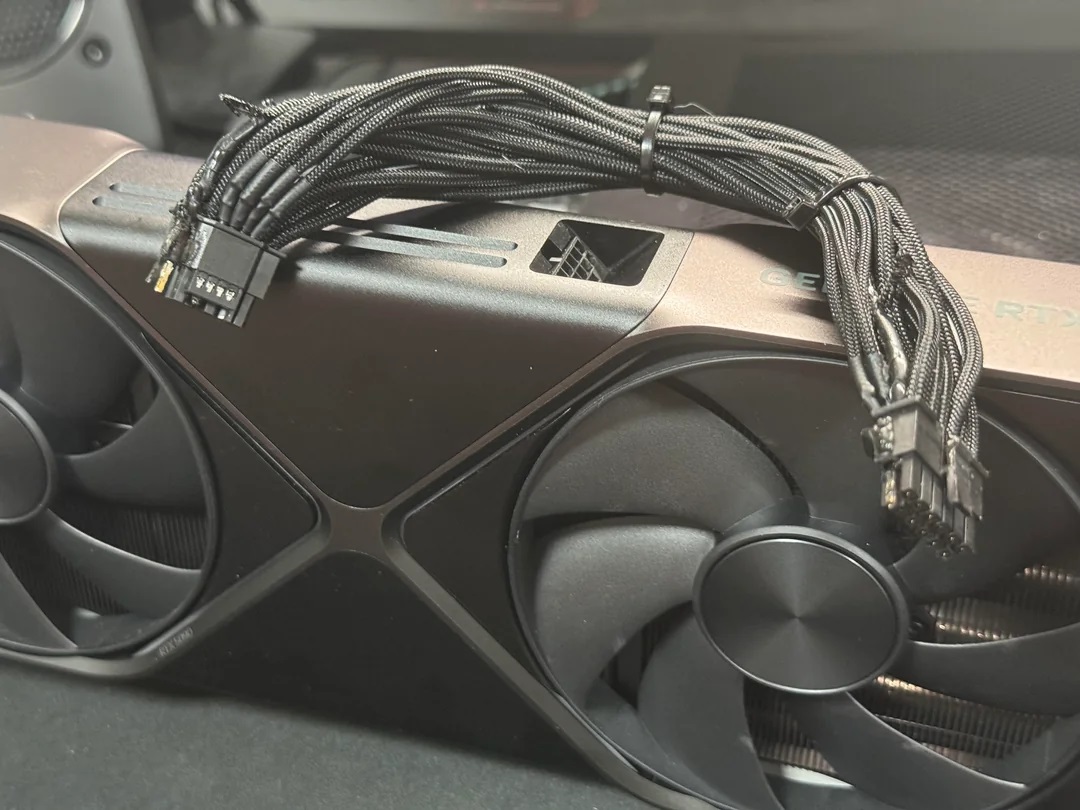 A damaged 12V-2×6 cable placed on top of an RTX 5090 Founders Edition graphics card