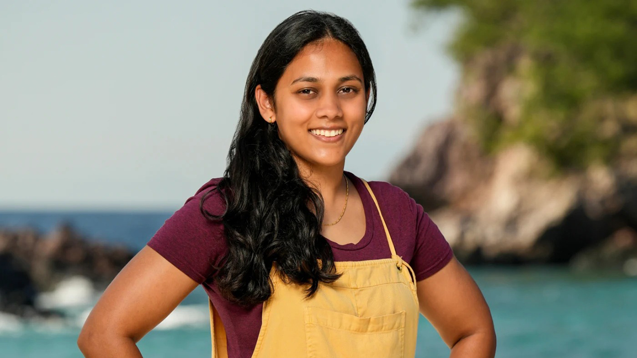 Kamilla from Survivor 48 posing on the beach with her hands on her hips.